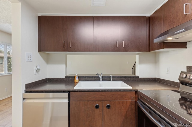6650 E Arizona Ave Unit 203, Denver, CO 80224 - kitchen with range with electric stovetop, stainless steel dishwasher, a sink, under cabinet range hood, and dark countertops