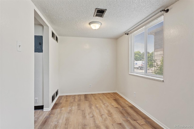 6650 E Arizona Ave Unit 203, Denver, CO 80224 - unfurnished room featuring light wood-style flooring, a textured ceiling, and baseboards