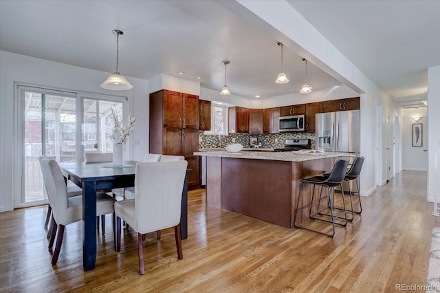 dining space with light wood-type flooring