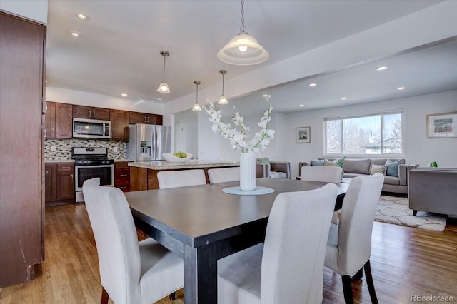 dining space featuring light wood-type flooring