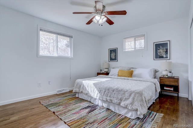 bedroom with dark hardwood / wood-style floors and ceiling fan