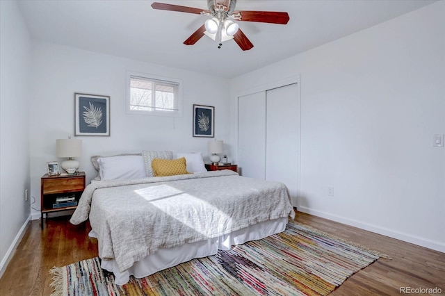 bedroom featuring ceiling fan, dark hardwood / wood-style flooring, and a closet