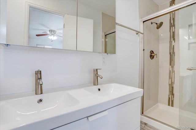 bathroom featuring vanity, a shower with door, and ceiling fan