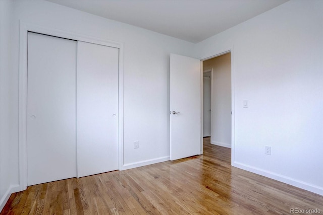 unfurnished bedroom featuring a closet and light hardwood / wood-style flooring