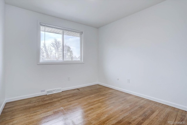 unfurnished room with light wood-type flooring