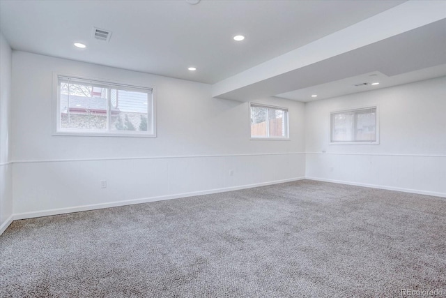 carpeted empty room featuring plenty of natural light