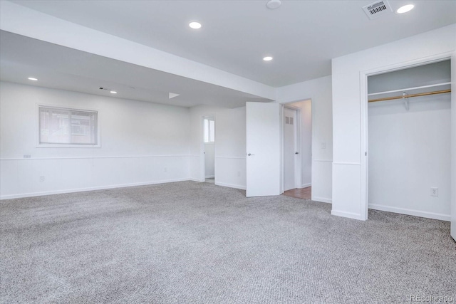 unfurnished bedroom featuring carpet floors and a closet