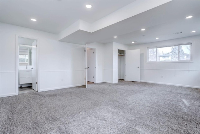 unfurnished bedroom featuring carpet, connected bathroom, and a closet