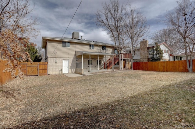 back of property featuring a patio, a yard, and a deck