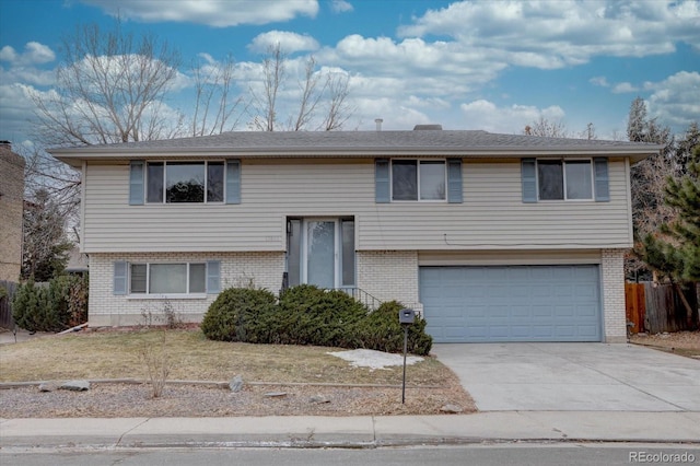 split foyer home featuring a garage and a front lawn