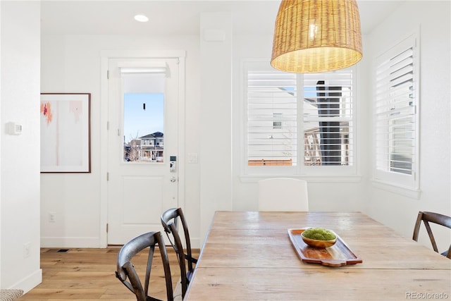 dining space featuring plenty of natural light, baseboards, and wood finished floors