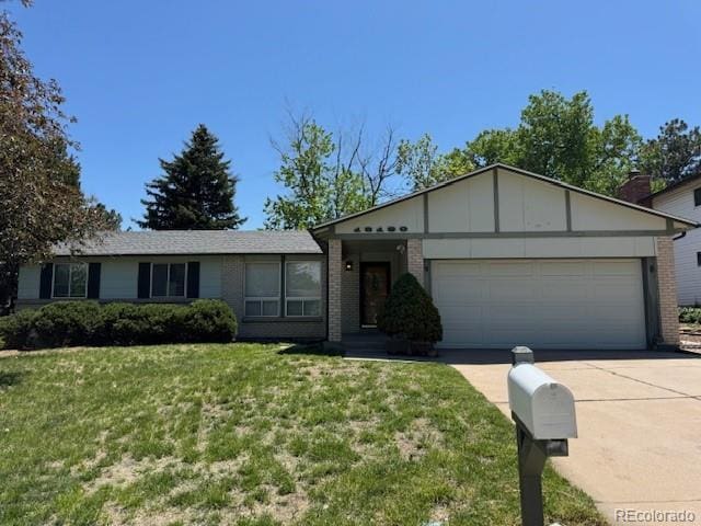 16180 E Flora Pl, Aurora, CO 80013 - ranch-style house featuring concrete driveway, an attached garage, a front lawn, brick siding, and board and batten siding