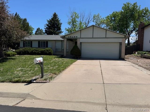 16180 E Flora Pl, Aurora, CO 80013 - single story home featuring concrete driveway, an attached garage, a front yard, brick siding, and board and batten siding