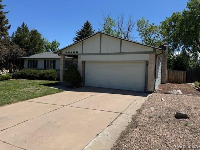 16180 E Flora Pl, Aurora, CO 80013 - single story home with brick siding, a garage, and driveway