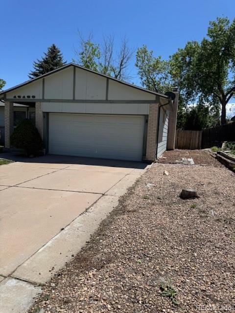 16180 E Flora Pl, Aurora, CO 80013 - view of front of home featuring brick siding, driveway, and an attached garage