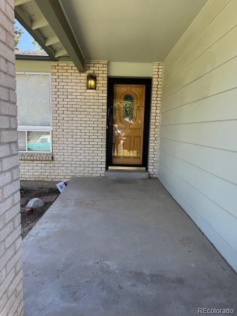 16180 E Flora Pl, Aurora, CO 80013 - doorway to property with brick siding