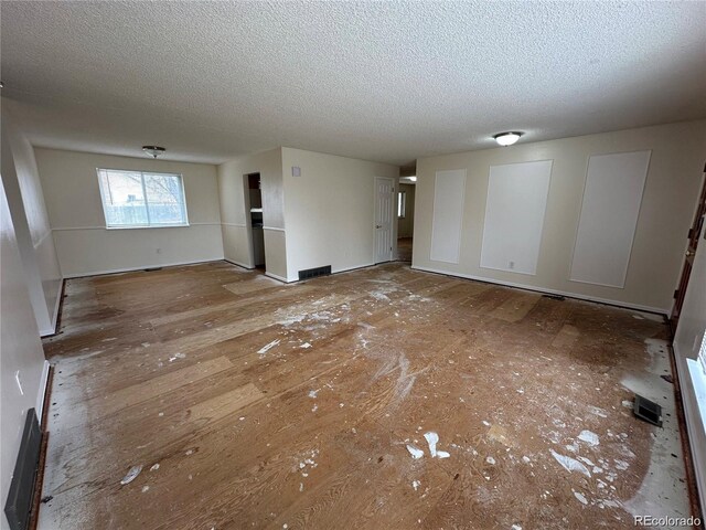 16180 E Flora Pl, Aurora, CO 80013 - unfurnished living room featuring a textured ceiling