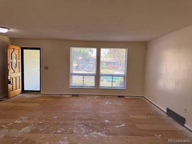 16180 E Flora Pl, Aurora, CO 80013 - unfurnished room with wood finished floors and baseboards