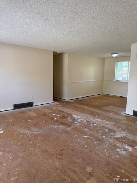 16180 E Flora Pl, Aurora, CO 80013 - unfurnished room featuring a textured ceiling and baseboards