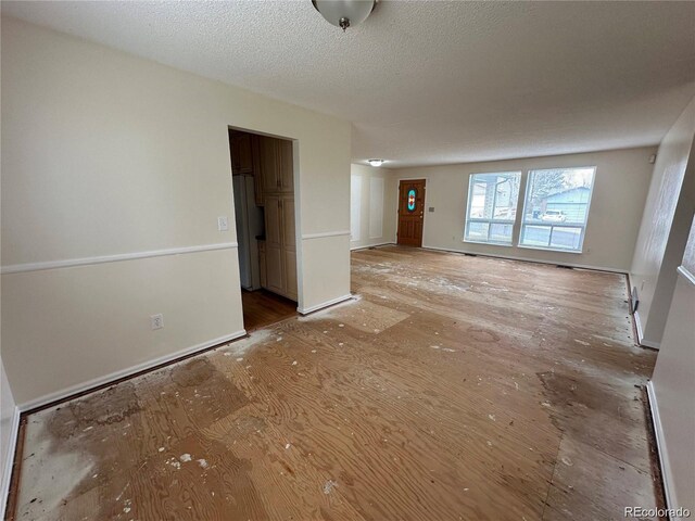 16180 E Flora Pl, Aurora, CO 80013 - spare room with baseboards and a textured ceiling
