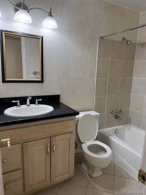 16180 E Flora Pl, Aurora, CO 80013 - bathroom with toilet, vanity, shower / washtub combination, and tile patterned flooring