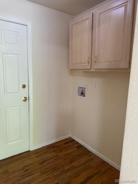 16180 E Flora Pl, Aurora, CO 80013 - washroom with washer hookup, dark wood finished floors, cabinet space, and baseboards