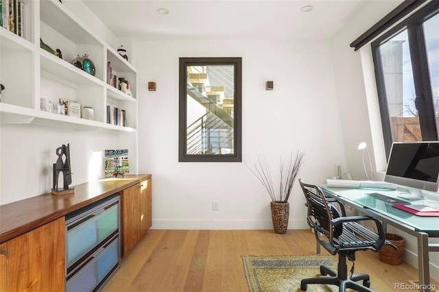 home office featuring light wood-style floors and baseboards