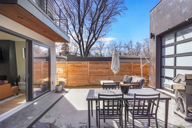 view of patio / terrace featuring outdoor dining space and fence