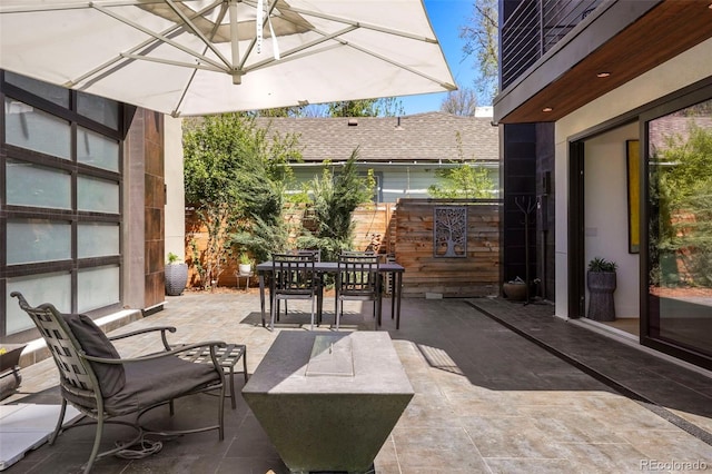 view of patio / terrace with outdoor dining space and fence