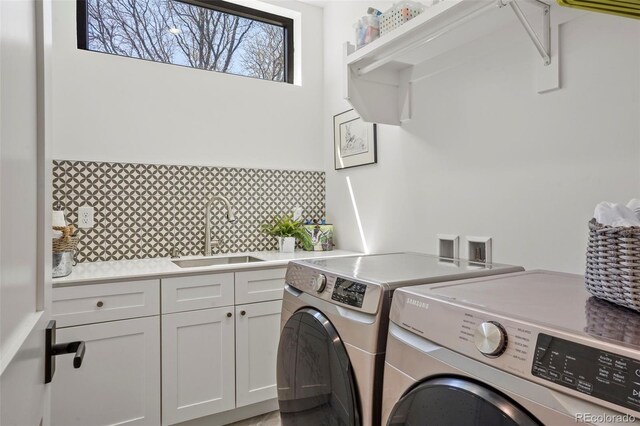 laundry room featuring a sink, cabinet space, and washing machine and dryer