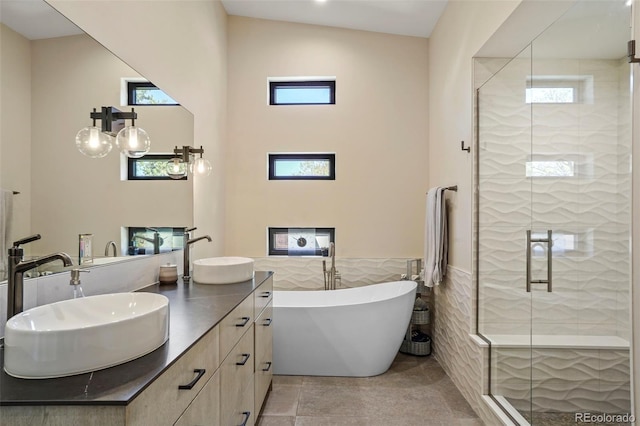 full bath with a shower stall, a healthy amount of sunlight, and a sink