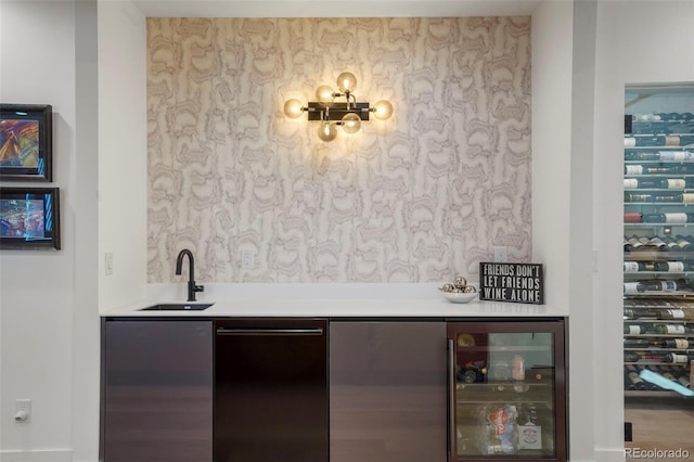 bar with indoor wet bar, a sink, and wine cooler
