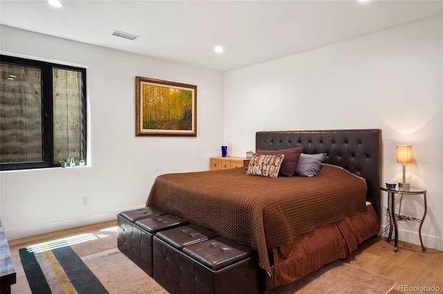 bedroom with visible vents, baseboards, recessed lighting, and wood finished floors