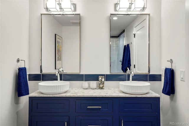 full bath featuring double vanity and a sink