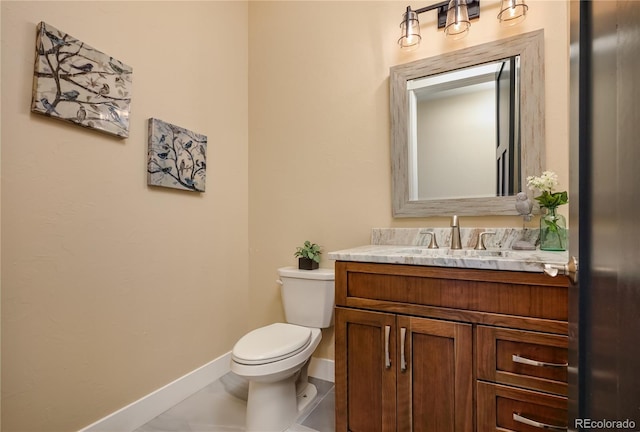 bathroom with tile patterned floors, vanity, and toilet