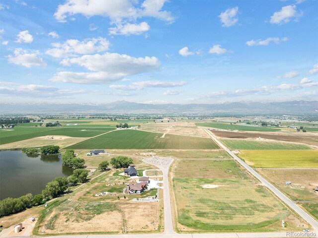 drone / aerial view with a rural view and a water and mountain view