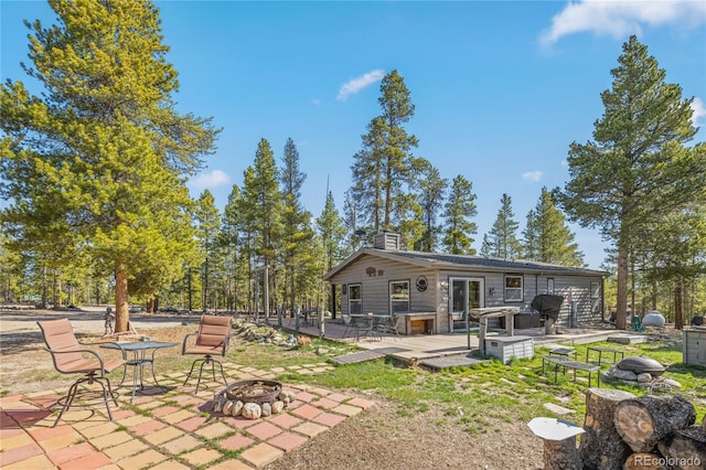 246 Spruce Dr, Twin Lakes, CO 81251 - back of house with a fire pit, a chimney, a wooden deck, and a patio area