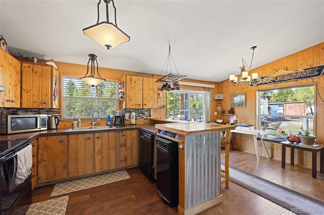 246 Spruce Dr, Twin Lakes, CO 81251 - kitchen with a sink, black appliances, plenty of natural light, dark wood-style flooring, and wood walls