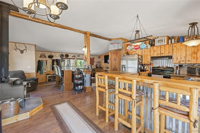 246 Spruce Dr, Twin Lakes, CO 81251 - kitchen with stainless steel appliances, a chandelier, wood finished floors, extractor fan, and a wood stove