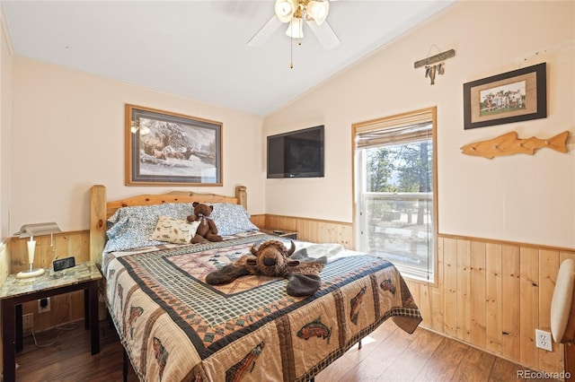 246 Spruce Dr, Twin Lakes, CO 81251 - bedroom with a wainscoted wall, lofted ceiling, wood walls, hardwood / wood-style flooring, and a ceiling fan