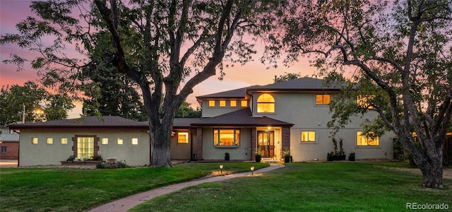 prairie-style home featuring a lawn