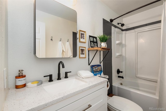 bathroom featuring toilet, vanity, and bathing tub / shower combination