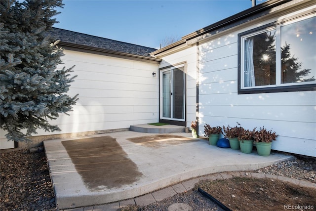 view of exterior entry featuring a patio area