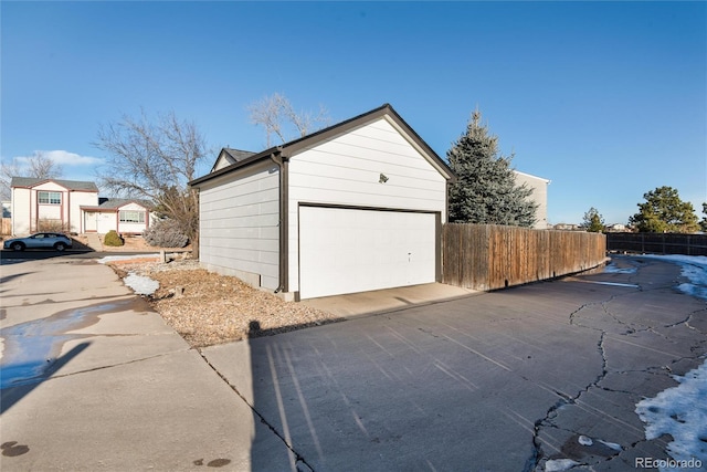 detached garage featuring fence