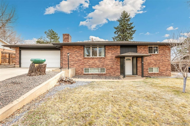 6614 Everett St, Arvada, CO 80004 - view of front of house featuring a chimney, brick siding, a garage, and driveway