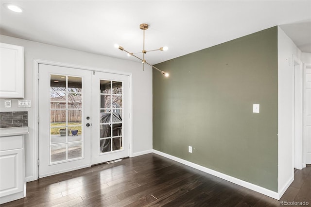 6614 Everett St, Arvada, CO 80004 - unfurnished dining area featuring french doors, a chandelier, and dark wood-style flooring
