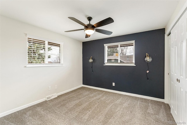 6614 Everett St, Arvada, CO 80004 - unfurnished bedroom featuring a closet, carpet flooring, multiple windows, and ceiling fan