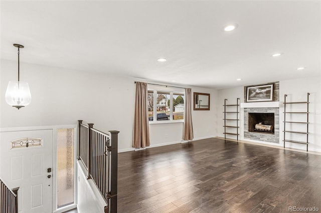6614 Everett St, Arvada, CO 80004 - unfurnished living room featuring recessed lighting, dark wood-style floors, and a fireplace