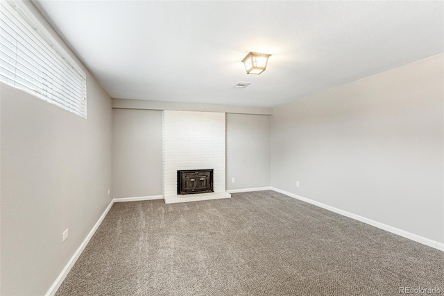 6614 Everett St, Arvada, CO 80004 - unfurnished living room with carpet floors and a brick fireplace