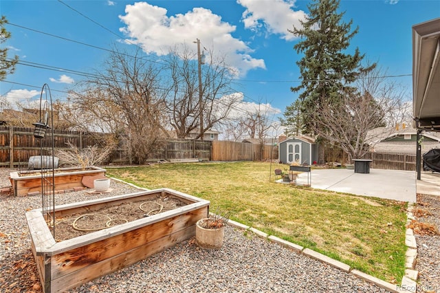 6614 Everett St, Arvada, CO 80004 - fenced backyard with a storage unit, a patio area, and a garden